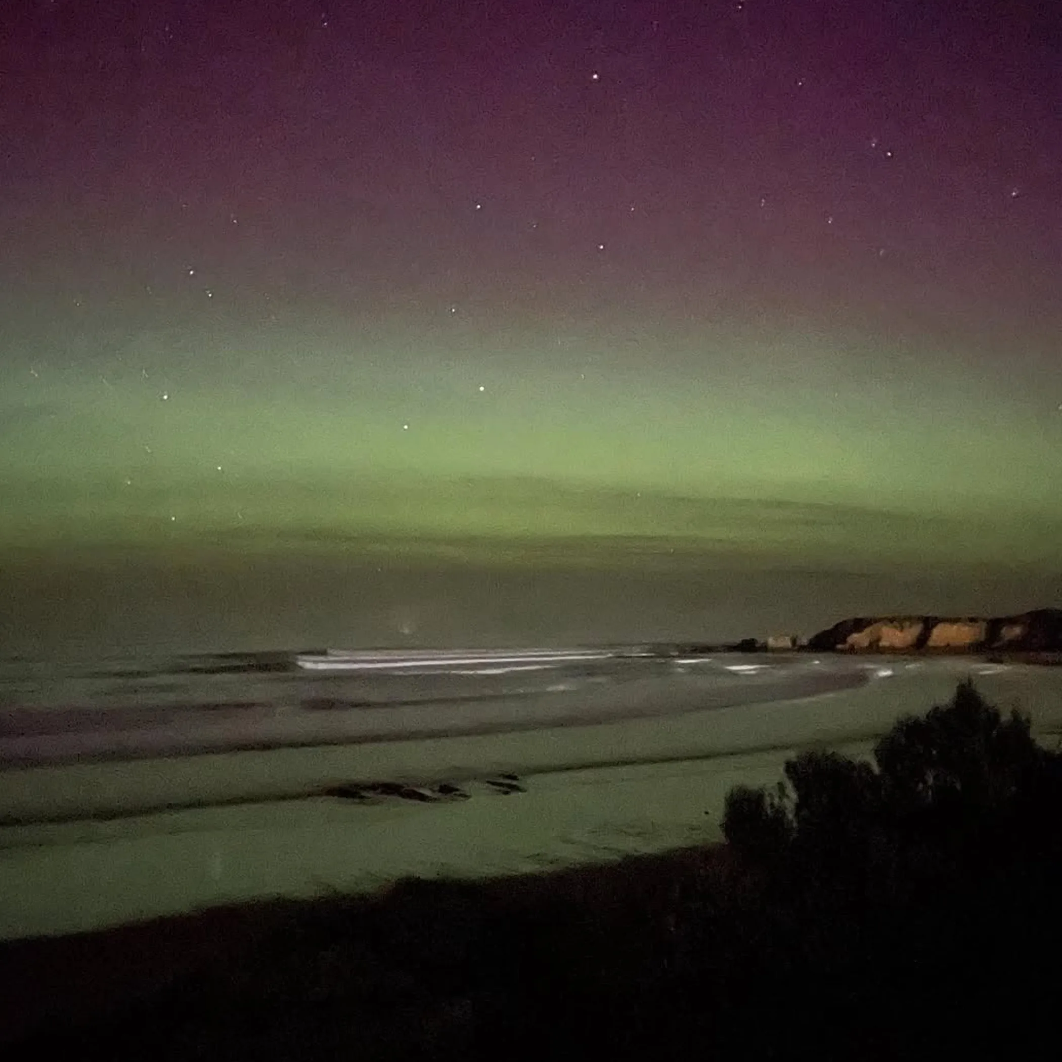 surf beach landscape beneath aurora